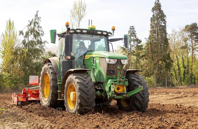 John Deere 6R 185 mid-size tractor with Kuhn HR power harrow for intensive seedbed preparation. Shottisham, Suffolk, England, UK