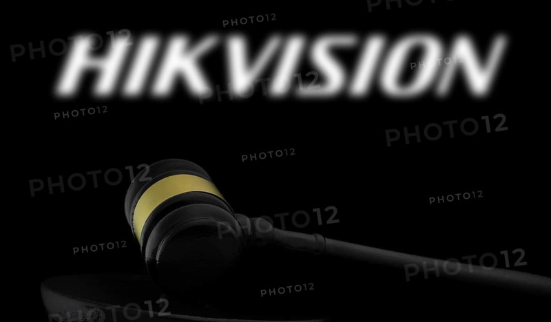 Court gavel in front of the Hikvision logo.