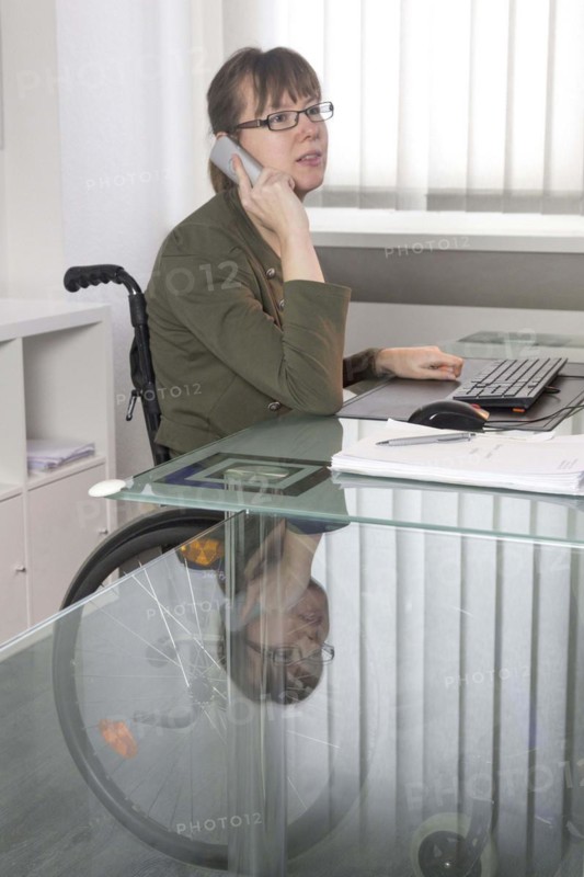 Young woman in a wheelchair at her workplace, Berlin, 18/01/2017
