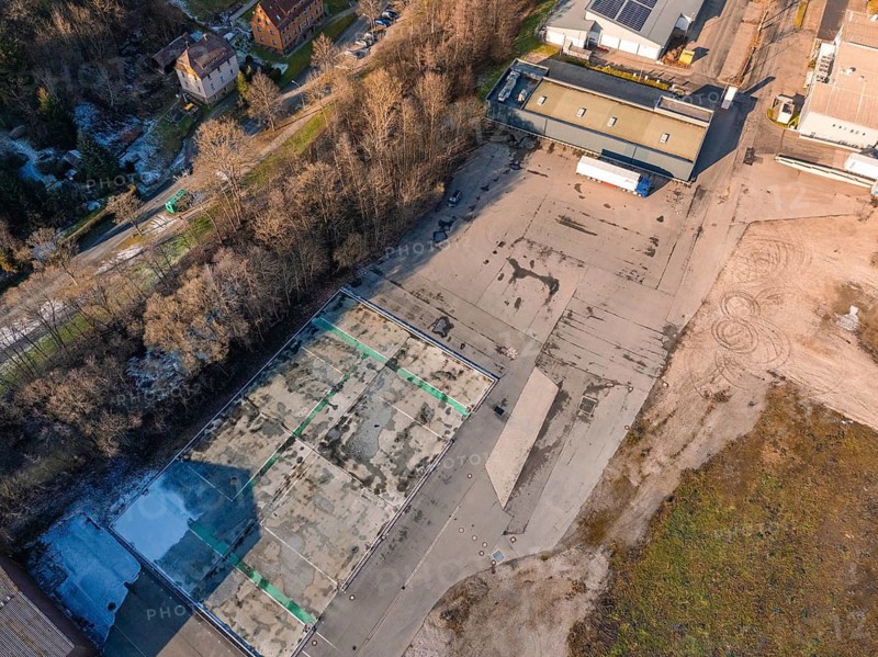 Aerial view of a factory site surrounded by trees in wintry surroundings, Nagold, Black Forest, Germany