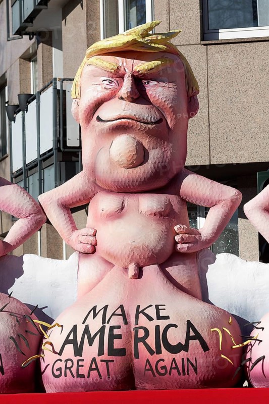 US President Donald Trump with large scrotum, Make America Great Again, papier-mâché figure, themed float by Jacques Tilly, Rosenmontagszug 2025, Düsseldorf, Rhineland, North Rhine-Westphalia, Germany