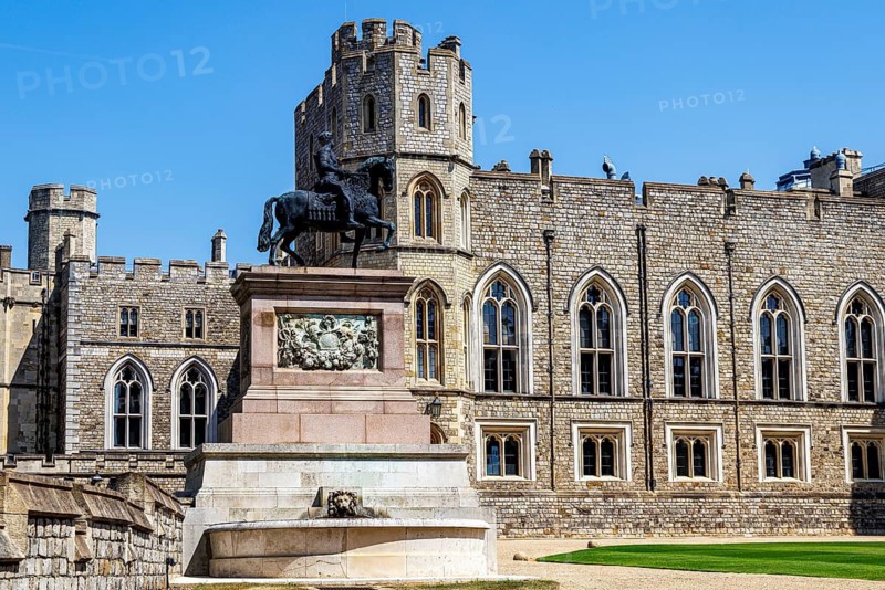 A bronze equestrian statue of King Charles II stands before the Round Tower in the Quadrangle, cast by Josias Ibach in 1679 with a marble plinth carved by Grinling Gibbons, commemorating the king who restored the monarchy in 1660, Windsor, England, United Kingdom