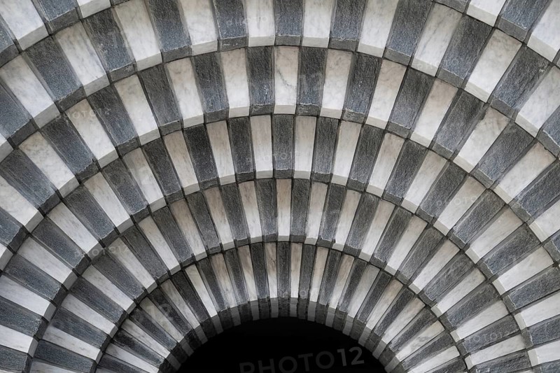 Marble and gneiss alternating in layers, round arch, interior, Roman Catholic church of San Giovanni Battista, built in the same place as the village church destroyed by avalanche in 1986, architect Mario Botta, Mogno, Maggia Valley, Valle Maggia, municipality of Lavizzara, Canton of Tessin, Switzerland