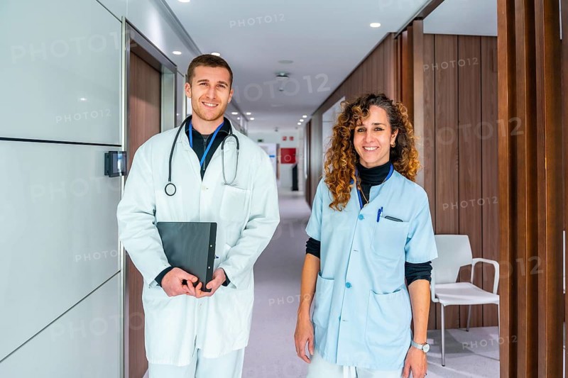 Portrait of two members of medical staff of the hospital standing in the corridor