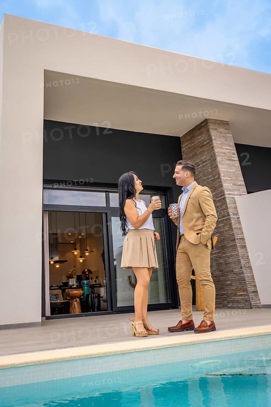 Vertical photo of a relaxed couple celebrating that they bought a luxury house