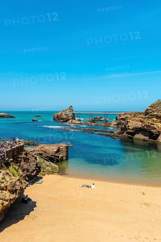 The beautiful Plage du Port Vieux on a summer afternoon where bathers can be seen bathing. Municipality of Biarritz, department of the Atlantic Pyrenees. France