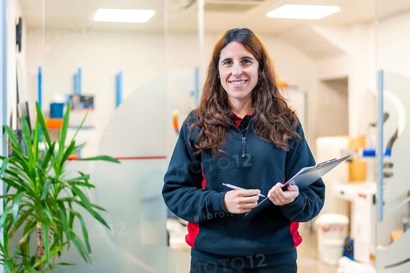 Portrait of a female smiling engineer in a modern cnc factory