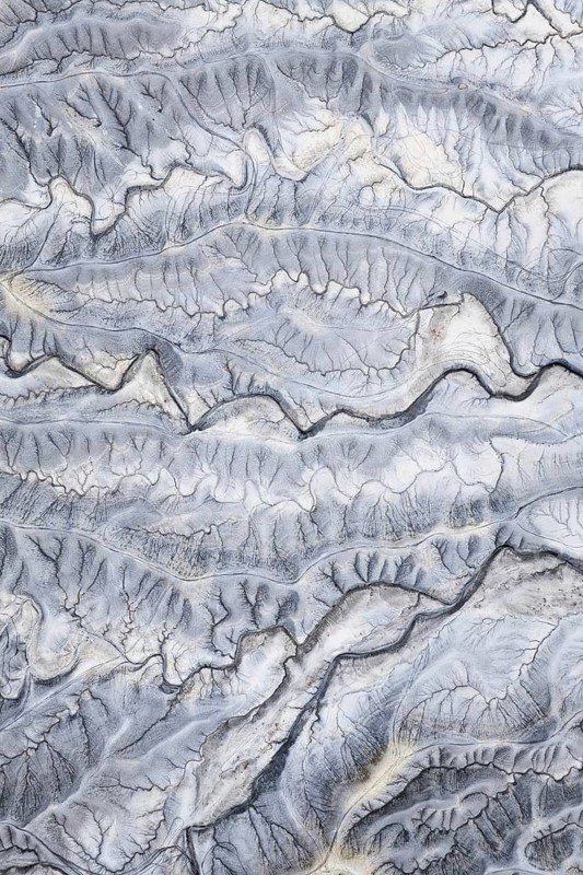 Captivating aerial shot of the intricate, textured landscape of Moonscape Overlook in Utah, showcasing its unique geological features