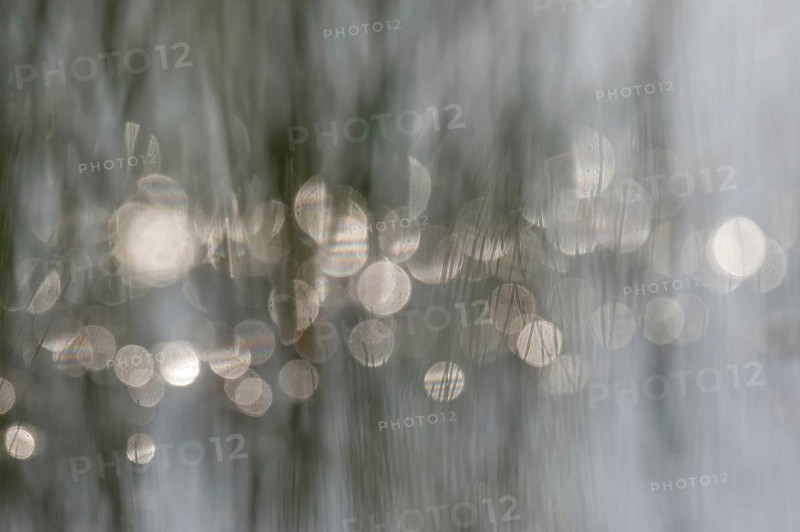 In the morning, lights are reflected on the water surface. The natural light creates blurry reflections on the water. You can see small waves. Bas-Rhin, Alsace, France