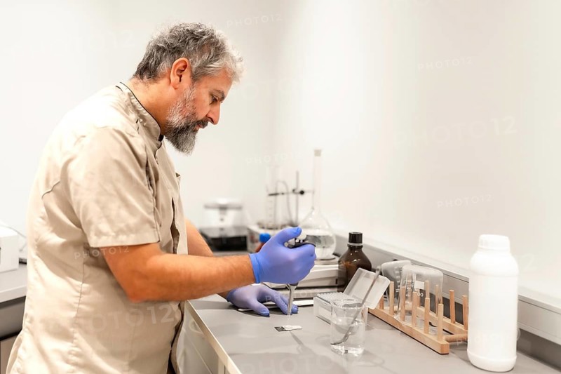 Mature male pharmacist doctor testing samples in the laboratory