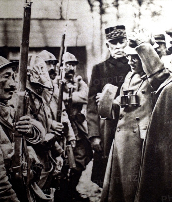 World War I. On the Verdun front, Prince Alexander of Serbia trying on a soldier's helmet