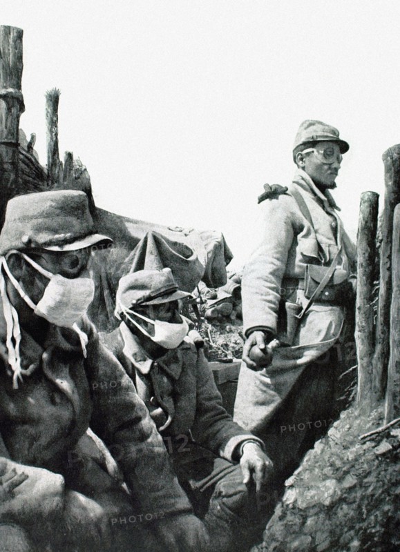 In a front-line trench in Vauquois, a soldier prepares to throw a grenade