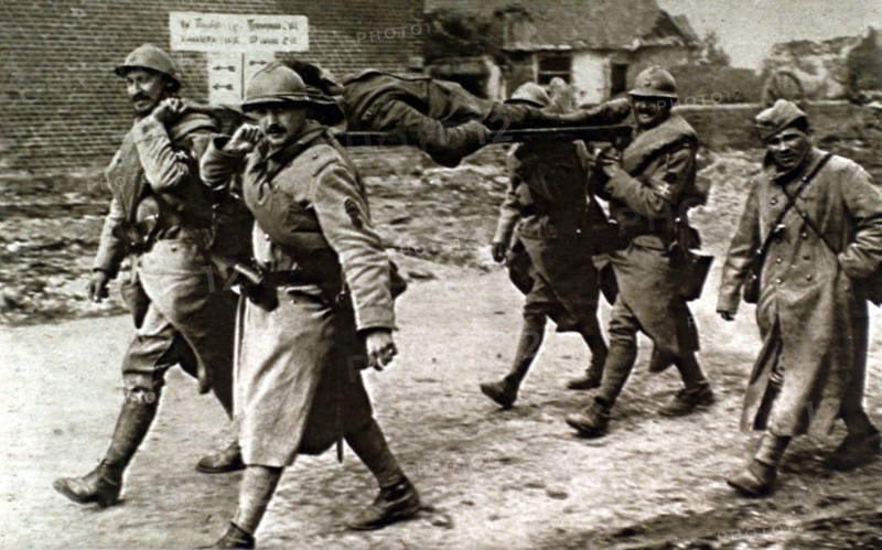 World War I. At the front, French soldiers carrying a wounded English soldier