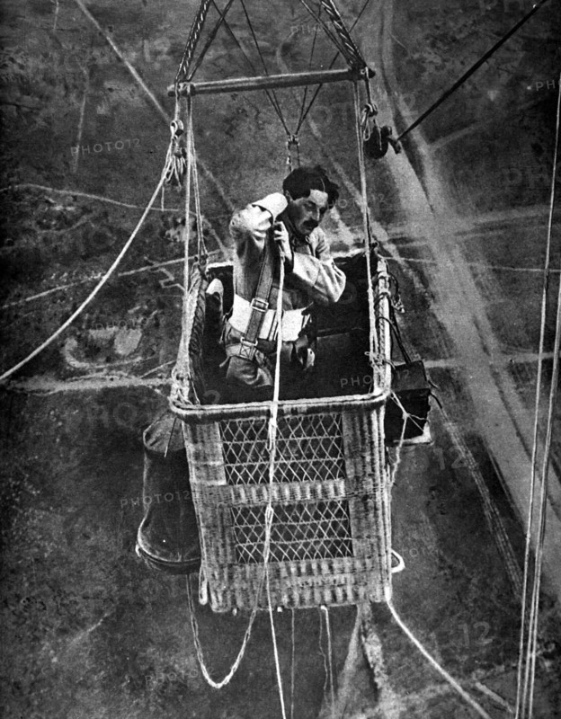 World War I. The observer of a captive hot-air ballon called "Sausage" checking the straps of his parachute (1917)