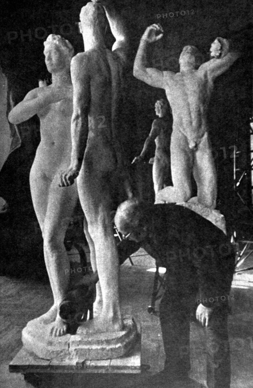 German sculptor Georg Kolbe putting the final touches on one of his sculptures, "Mars and Venus" (1941)
