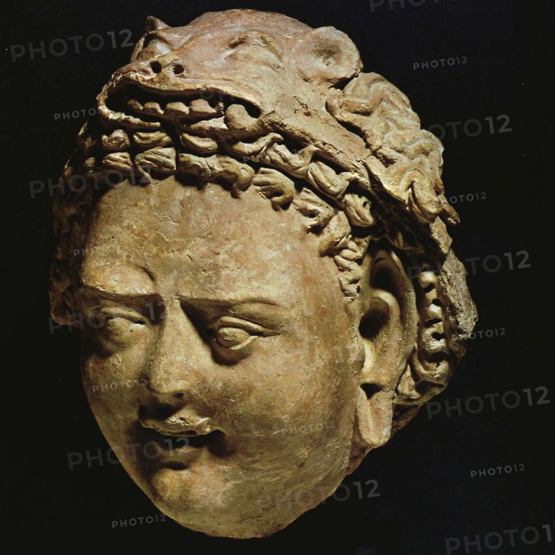 Demon with stylized leonine headdress, moulded clay