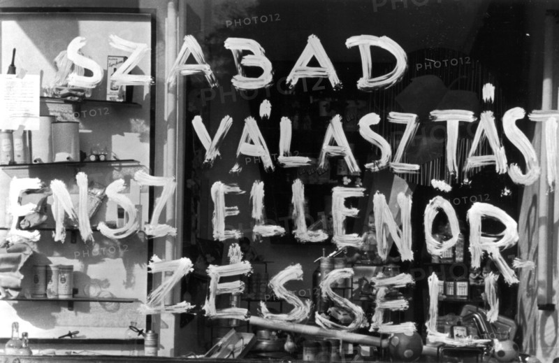1956, Budapest, a slogan on a shop window reads: "A free election under the control of..."