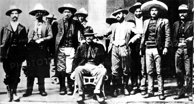 General Orozco, surrounded by members of his staff and other revolutionary comrades, in the makeshift campgrounds of those who were occupying Ciudad Juarez