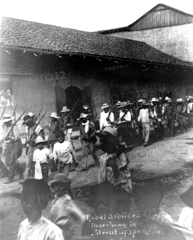Rebel soldiers marching in the street in Leon