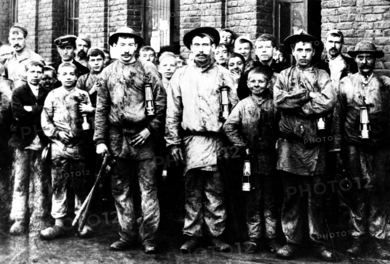 Group of children and men working in the mine of Denain, France