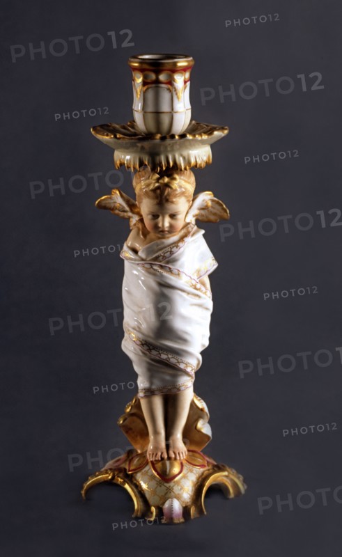 Candle holder with vettoed cherub