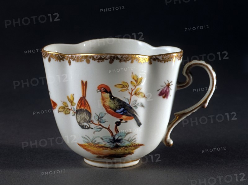 Small cup decorated with birds and insects.