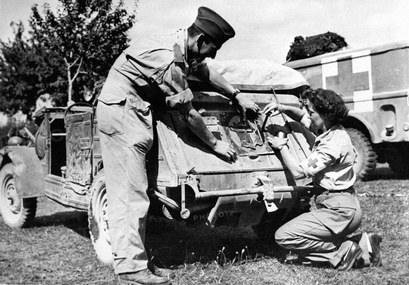 Un ambulancier français décore une "Volkswaggon" en France. (Août 1944)