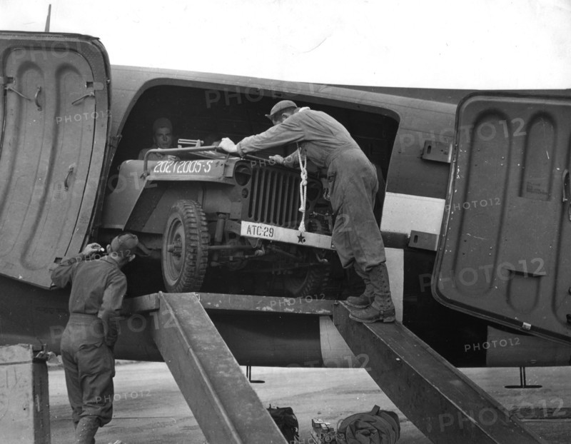 A Jeep comes out of a C-47 Skymaster. Orly Airport July 2, 1945
