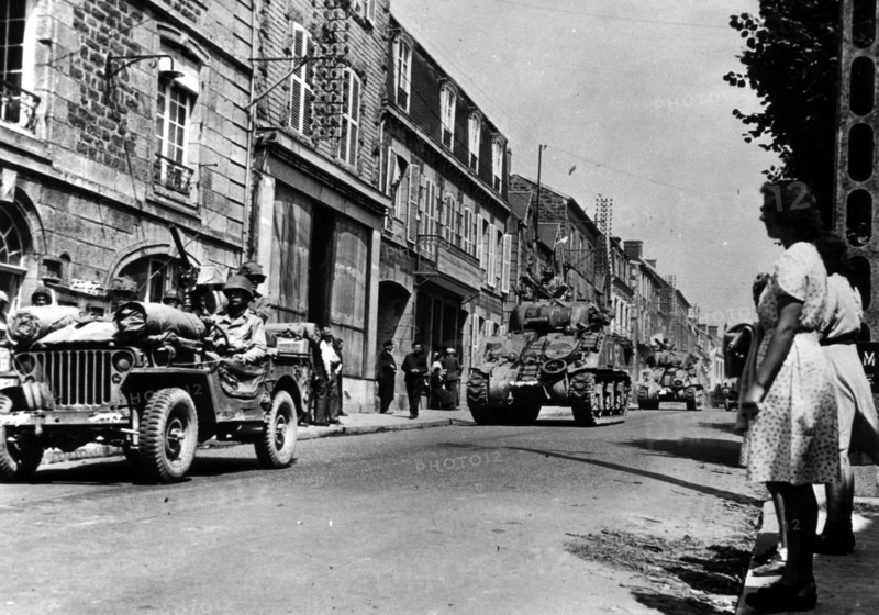 U.S troops pass Brehal (Frace) on their way to capture Avranches
