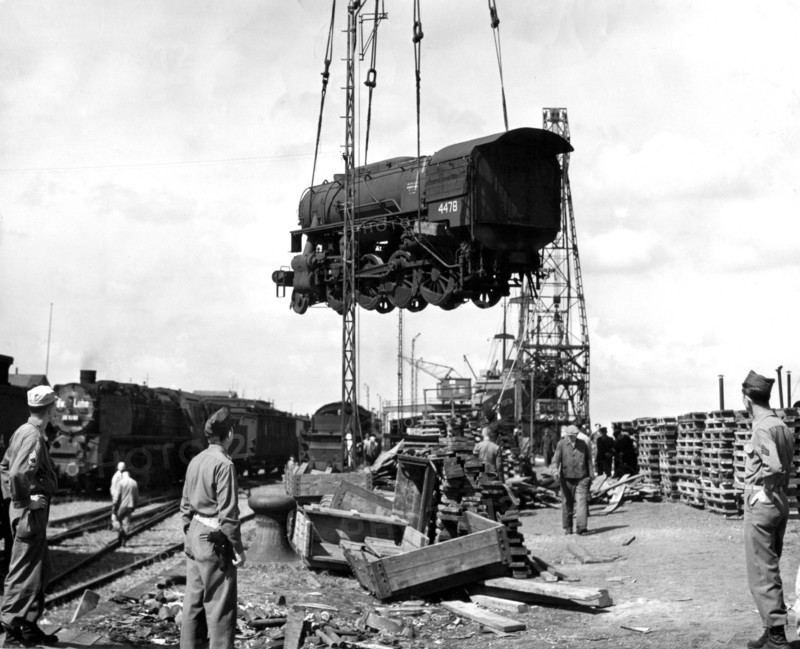 The first locomotive is unloaded from a libery ship at Bremenhaven (Germany) July 18,1945