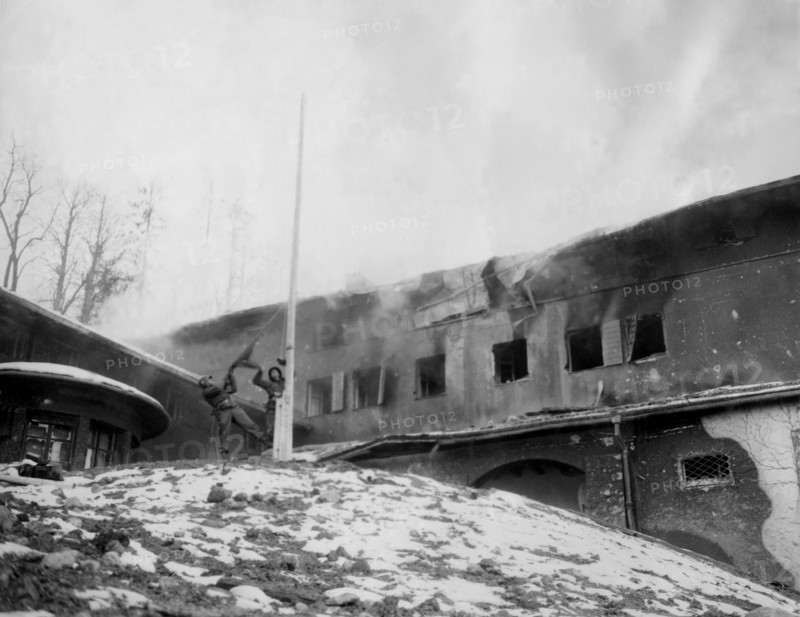 U.S. soldiers rip Nazi flag from Hitler's Berchtesgaden blazing retreat (May 4, 1945)