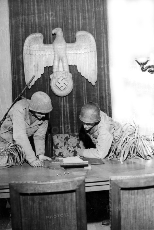 Soldats américains inspectant le bureau d'un dirigeant nazi à Hardt, en Allemagne. (1er mars 1945)