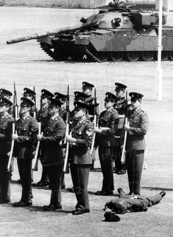 An unconscious soldier during the birthday parade for the British queen in Berlin