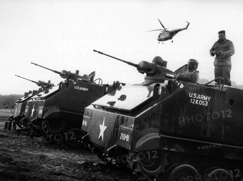 Armoured tracked vehicle and helicopter at manoeuvre of US army in Berlin Grunewald