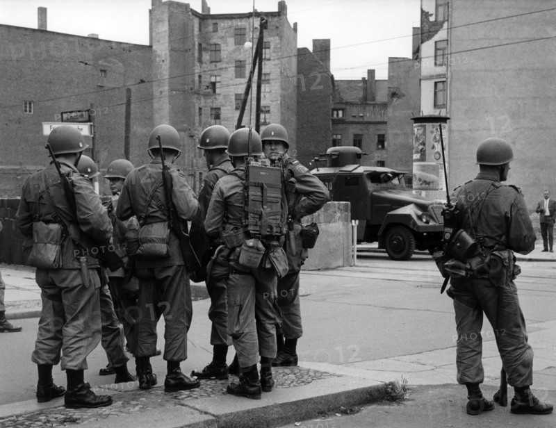 US soldiers in front of water cannon of People's Police at border crossing point Friedrichstrasse in Berlin 1961