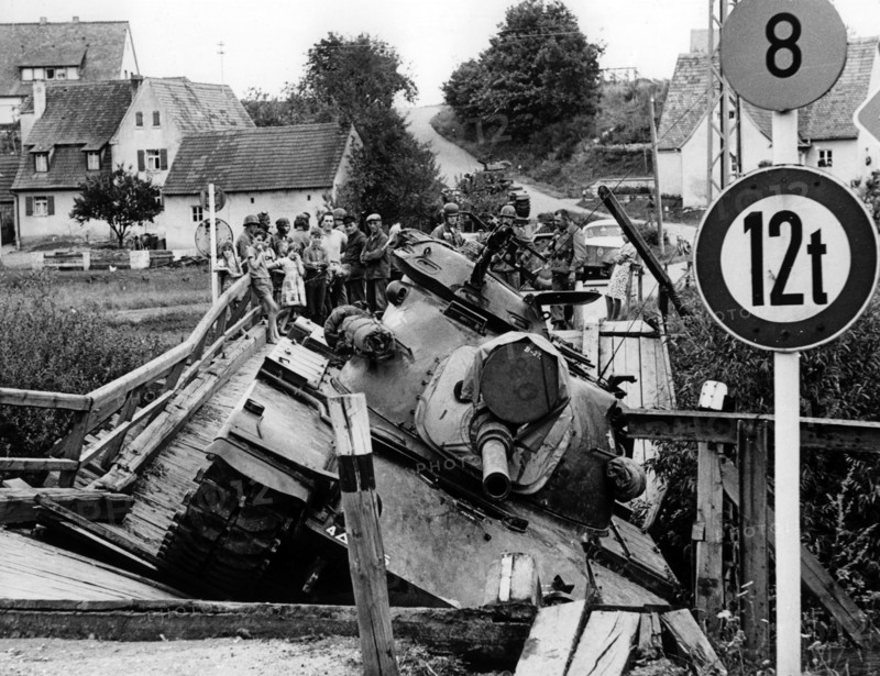 A bridge collapses under the weight of a U.S. tank