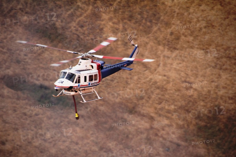 Photo taken on Dec. 20, 2019 shows a helicopter working at Lexton bush fire site in western Victoria, Australia