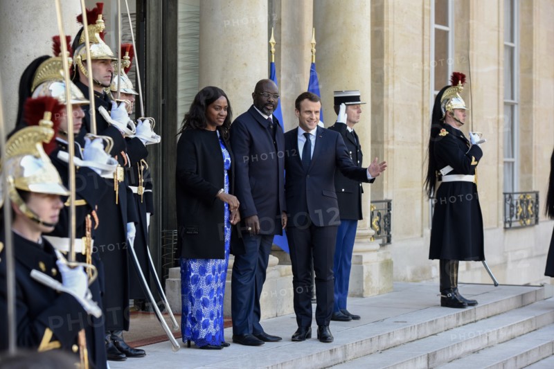 French President Emmanuel Macron and the newly elected visiting Leberian President George Weah pose for photos at Elysee Palace in Paris, France on Feb. 21, 2018.