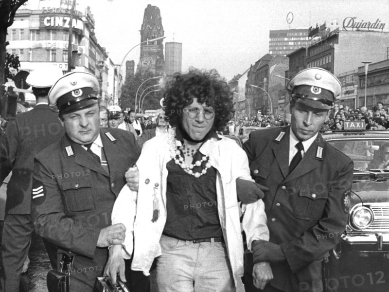 The Communard Rainer Langhans is taken away by two police officers after his arrest
