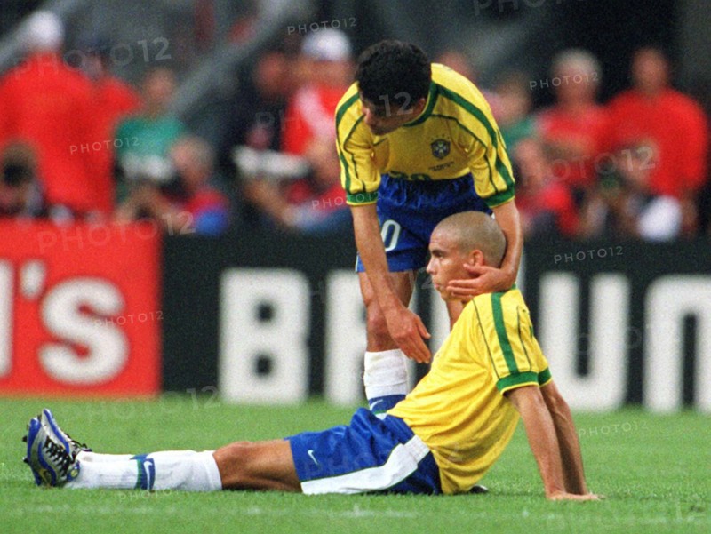 Brazilian forward Bebeto (standing) comforts his teammate Ronaldo after the 1998 World Cup final France against Brazil at the Stade de France in Saint Denis, Paris, France, 12 July 1998. France won the game 3-0 (2-0)against titleholder Brazil and won the world championship title for the first time.