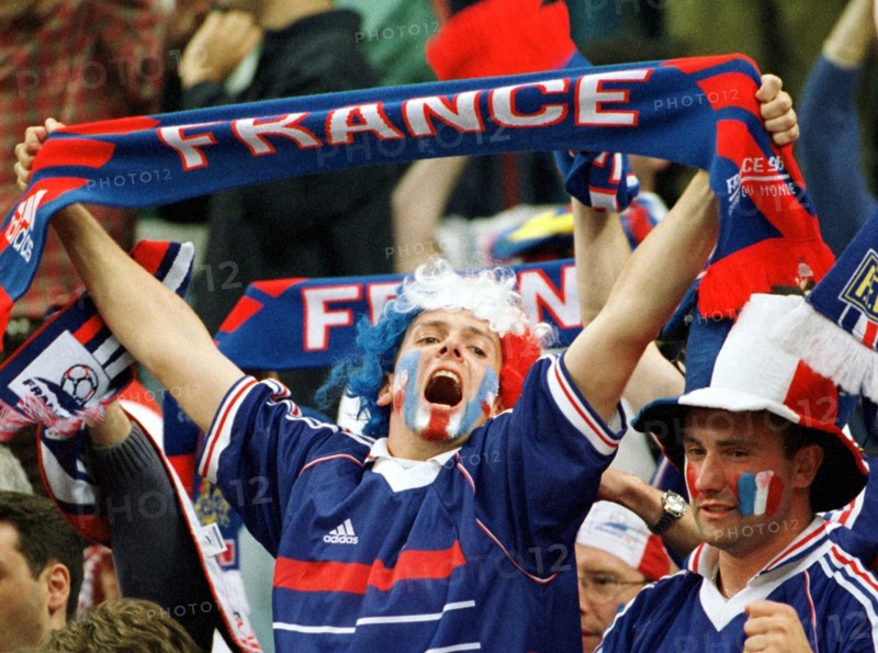 A French supporter holds up his fan scarf and frenetically cheers on his team during the World Cup semi-final game France against Croatia in Saint Denis, near Paris, France, 8 July 1998. France wins by a score of 2-1 and advances to the final against defending champion Brazil.