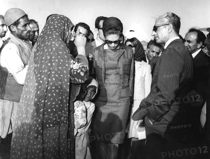 Reza Shah Pahlavi and his wife Farah visiting villagers in Iran