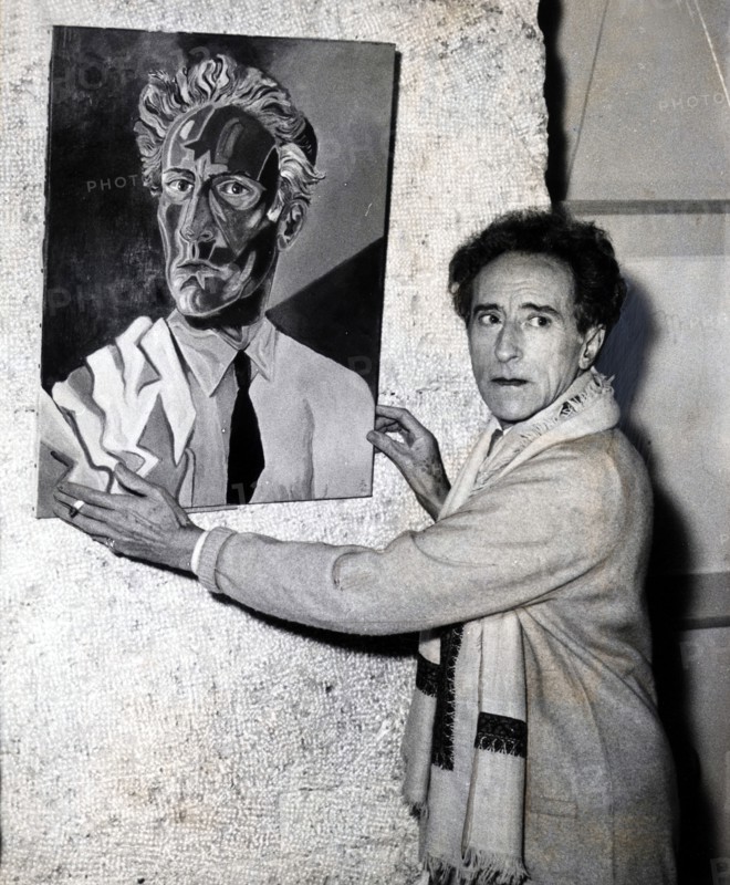 Cocteau hanging his painting for an exhibition in Nice, 1953