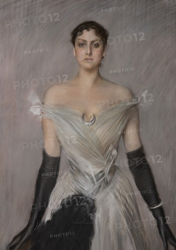 “Portrait of a lady in white with gloves and fan” by Giovanni Boldini