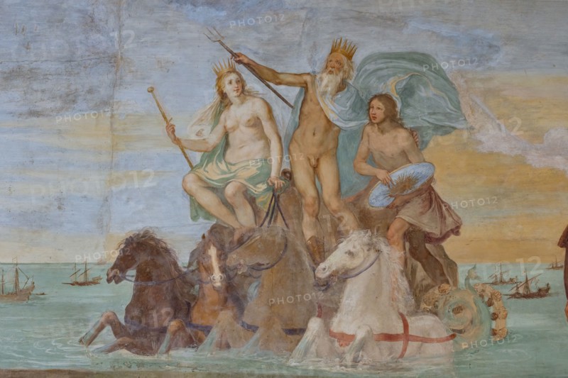 Medici Villa La Petraia, courtyard:“Dominance of Tuscany over the sea”, fresco from the cycle of the Fasti Medicei by Volterrano (Baldassarre Franceschini), 1636-1647.
The scene is set in Livorno, the Medici port and ideal city refounded by Francesco I de' Medici and his brother Ferdinand I, in the shadow of the monument of the Four Moors, with the statue of Ferdinand crowned by two winged victories. In the centre, in the background, Neptune's chariot proceeds, with Galatea and Perseus (holding Medusa's shield), to which the sea god points the statue. They sail among a large group of galleys of the Order of Saint Stephen.
On the right, in front of a cloth held up by putti in the face and under a personification of Fame, we see the allegories of Tuscany (with the crossed shield), of the Grand Duchy (with crown, scepter and mantle with the crest of the Order) and of Livorno, with the castle coat of arms.
Detail.
Villa medicea La Petraia, Firenze (FI) - Florence, Toscana - Tuscany, It...