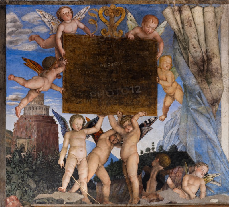 Ducal Palace: south-west wall of the “Bridal Chamber or Camera Picta", which is a room located in the north-east tower of the Castle of San Giorgio in Mantua. It is famous for the cycle of frescoes that covers its walls, a masterpiece by Andrea Mantegna, created between 1465 and 1474.
The wall, on the theme of “The Meeting” is divided into three sectors. Detail of the central one some cherubs hold a dedicatory plaque
Palazzo Ducale, Mantova (MN) - Mantua, Lombardia - Lombardy, Italia - Italy