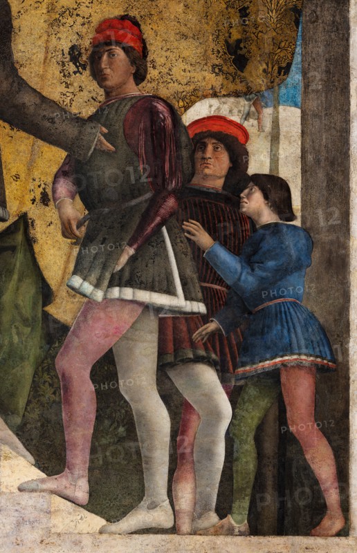 Ducal Palace: north-west wall of the “Bridal Chamber or Camera Picta", which is a room located in the north-east tower of the Castle of San Giorgio in Mantua. It is famous for the cycle of frescoes that covers its walls, a masterpiece by Andrea Mantegna, created between 1465 and 1474.
This wall represents “The Court” of Ludovico II Gonzaga. On the left, under the opened curtain, Ludovico sits while a secretary (perhaps Marsilio Andreasi or Raimondo Lupi di Soragna) hands him a letter. We see Rubino, Marquis Ludovico's favorite dog and symbol of loyalty, crouching. To her right, the only other person seated, is the Marquis's wife, Barbara of Brandenburg with a little girl, perhaps the youngest daughter Paola who seems to be offering her an apple. Behind Ludovico we can recognize the third-born Gianfrancesco standing, holding his hands on the shoulders of a child, perhaps the prothonotary Ludovicino. The man with the black hat is Vittorino da Feltre, tutor of the marquis and his childre...