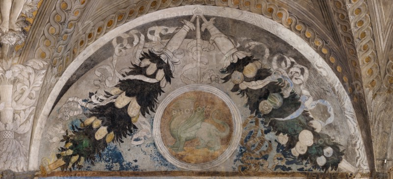 Ducal Palace: south-west wall of the “Bridal Chamber or Camera Picta", which is a room located in the north-east tower of the Castle of San Giorgio in Mantua. It is famous for the cycle of frescoes that covers its walls, a masterpiece by Andrea Mantegna, created between 1465 and 1474.
Detail of the lunette with festoons and heraldic symbols.
Palazzo Ducale, Mantova (MN) - Mantua, Lombardia - Lombardy, Italia - Italy