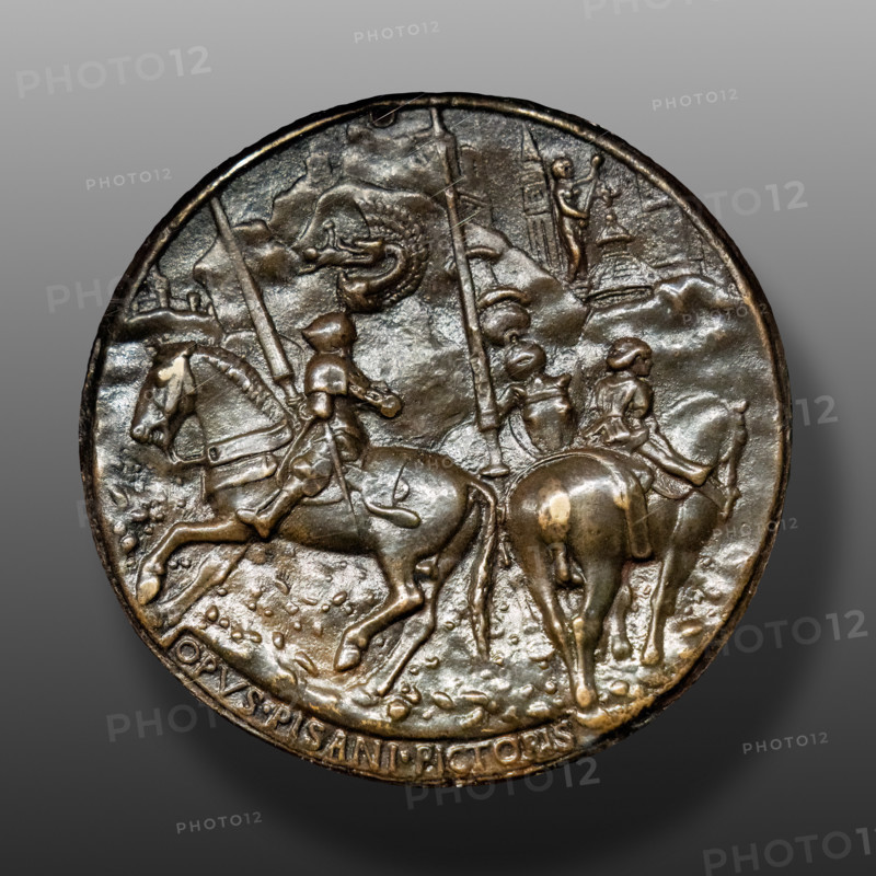 “Filippo Maria Visconti in armi con scudieri”, medaglia in bronzo di Pisanello (Antonio di Puccio Pisano), dopo 1441. Retro. 
Visconti indossa un alto cimiero con biscione che divora un saraceno. Nelle architetture sullo sfondo sono probabilmente rappresentati il Torrazzo e il Battistero di Cremona. 

[ENG]
“Filippo Maria Visconti in Arms with his Squires”, bronze medal, by Pisanello (Antonio di Puccio Pisano), 1441. Reverse.
Visconti wears a tall crest with a snake devouring a Saracen. The Torrazzo and the Baptistery of Cremona are probably represented in the architecture in the background.
Castello Sforzesco, Gabinetto nu, Milano (MI) - Milan, Lombardia - Lombardy, Italia - Italy