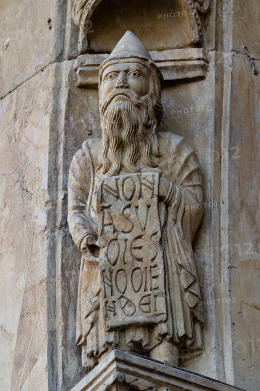 Fidenza, Duomo (Cattedrale di San Donnino), facciata, portale maggiore: dettaglio dell’archivolto con una delle figure di profeti raffiguranti I comandamenti con l’iscrizione: NON / A[B]SV/MES / NOME/N [DOMINI] DE[I] = Non userai il nome di Dio. (Es 20, 7). 
Opera di Benedetto Antelami e bottega.

[ENG]
Fidenza, Duomo (Cathedral of San Donnino), facade, main portal: detail of the archivolt with one of the figures of prophets depicting the commandments with the inscription: NON / A[B]SV/MES / NOME/N [DOMINI] DE[I] = You shall not use the name of God. (Ex 20, 7).
Work by Benedetto Antelami and workshop.
Cattedrale di San Donnino, Fidenza (PR), Emilia-Romagna, Italia - Italy